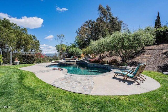 view of swimming pool featuring a patio area, a lawn, a pool with connected hot tub, and fence