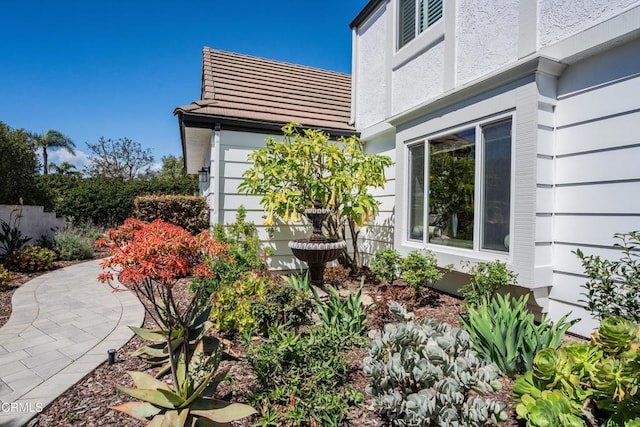 view of home's exterior with a tile roof