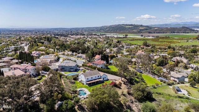 drone / aerial view featuring a residential view and a mountain view