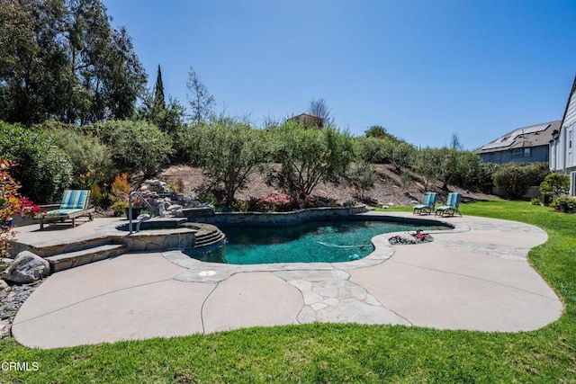 outdoor pool with a yard, a patio area, and an in ground hot tub