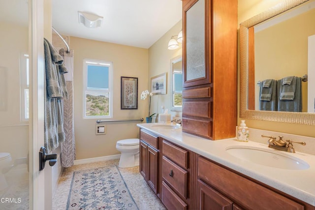 full bathroom with a shower with shower curtain, double vanity, toilet, and a sink