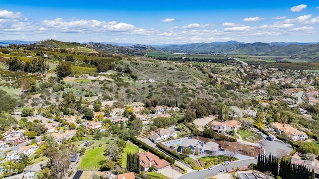 drone / aerial view featuring a residential view and a mountain view