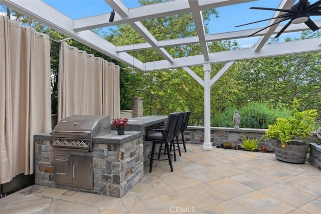 view of patio featuring a pergola, outdoor dry bar, exterior kitchen, and area for grilling