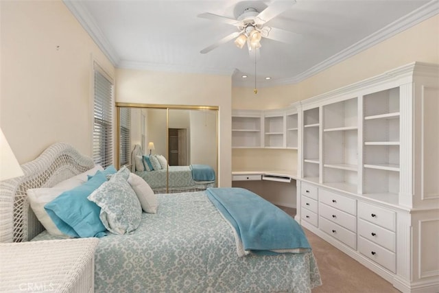 carpeted bedroom featuring ceiling fan, crown molding, and a closet