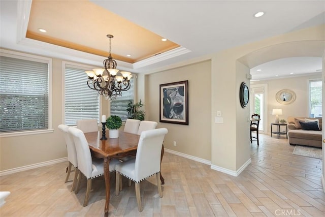 dining room with recessed lighting, arched walkways, a chandelier, and ornamental molding