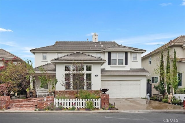 traditional home with fence, a tiled roof, stucco siding, driveway, and a garage