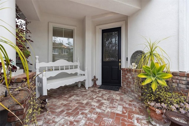 entrance to property with stucco siding