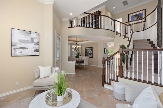 foyer featuring baseboards, ornamental molding, stairs, and recessed lighting