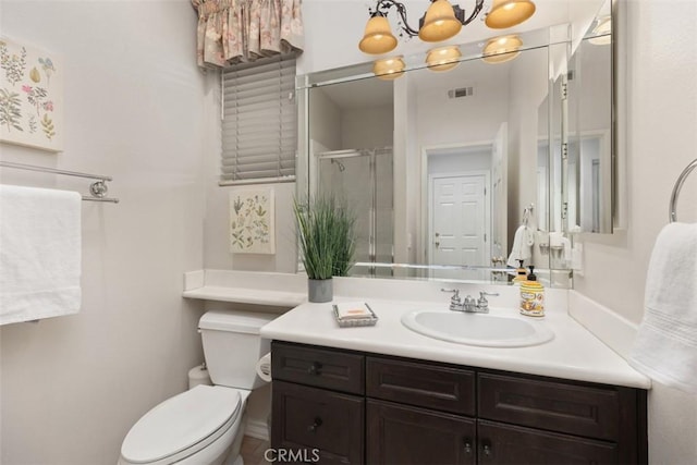 bathroom featuring a shower stall, vanity, a chandelier, toilet, and visible vents