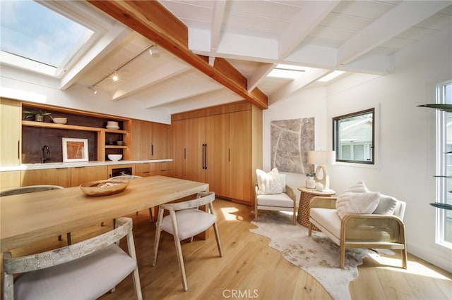 2604 Victoria Dr, Laguna Beach, CA 92651 - dining room with a skylight, light wood-style flooring, beamed ceiling, and track lighting