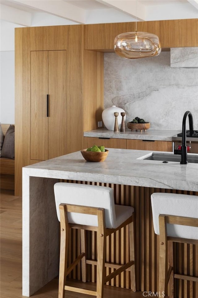 2604 Victoria Dr, Laguna Beach, CA 92651 - kitchen with a breakfast bar, light countertops, a sink, and modern cabinets