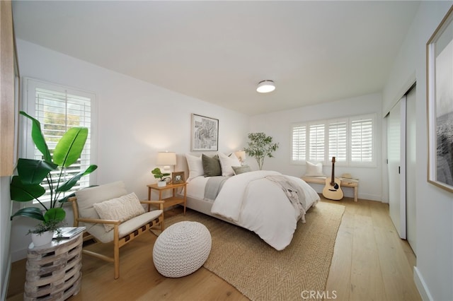 2604 Victoria Dr, Laguna Beach, CA 92651 - bedroom featuring light wood finished floors, multiple windows, and a closet
