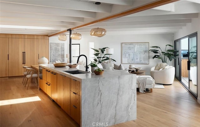 2604 Victoria Dr, Laguna Beach, CA 92651 - kitchen featuring a sink, beam ceiling, modern cabinets, light wood-style flooring, and open floor plan
