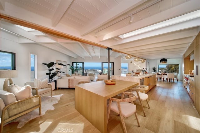 2604 Victoria Dr, Laguna Beach, CA 92651 - kitchen featuring open floor plan, beamed ceiling, a spacious island, light wood-style flooring, and a sink