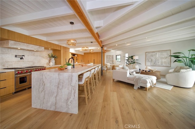 2604 Victoria Dr, Laguna Beach, CA 92651 - kitchen with premium range, exhaust hood, open floor plan, modern cabinets, and beamed ceiling