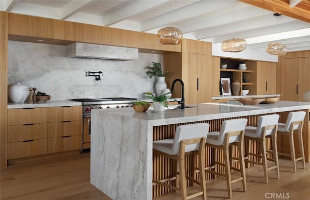 2604 Victoria Dr, Laguna Beach, CA 92651 - kitchen with modern cabinets, stainless steel stove, beam ceiling, and light wood-style flooring