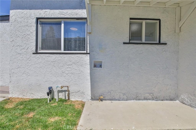 view of side of property with stucco siding