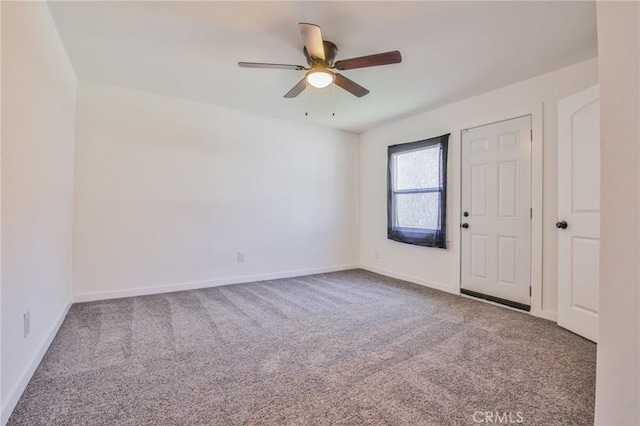 empty room with baseboards, carpet floors, and a ceiling fan