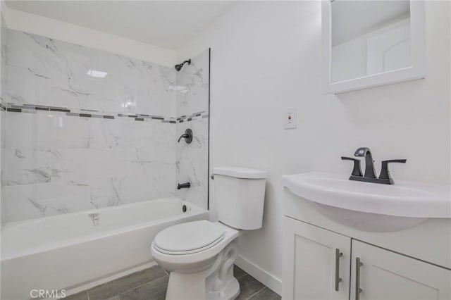 bathroom with shower / bathing tub combination, vanity, toilet, baseboards, and wood finished floors