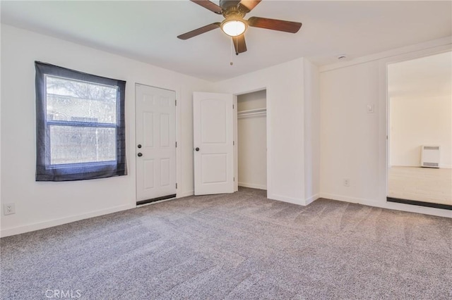 unfurnished bedroom with baseboards, ceiling fan, a closet, and carpet floors