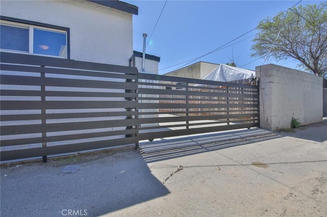 view of gate with a fenced front yard