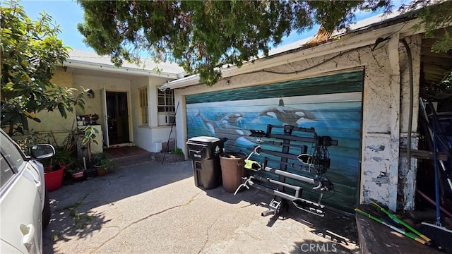 view of property exterior with stucco siding and driveway
