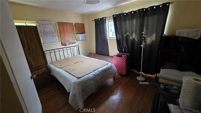 bedroom with a textured ceiling and wood finished floors