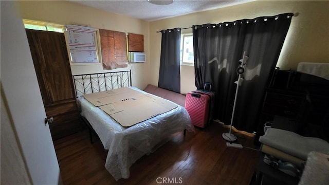bedroom featuring a textured ceiling and wood finished floors