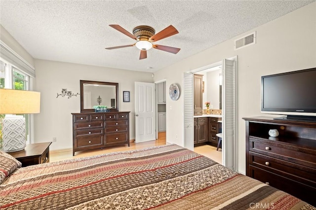 20140 Bouma Ct, Cerritos, CA 90703 - bedroom featuring a textured ceiling, ensuite bath, light wood-style floors, and ceiling fan