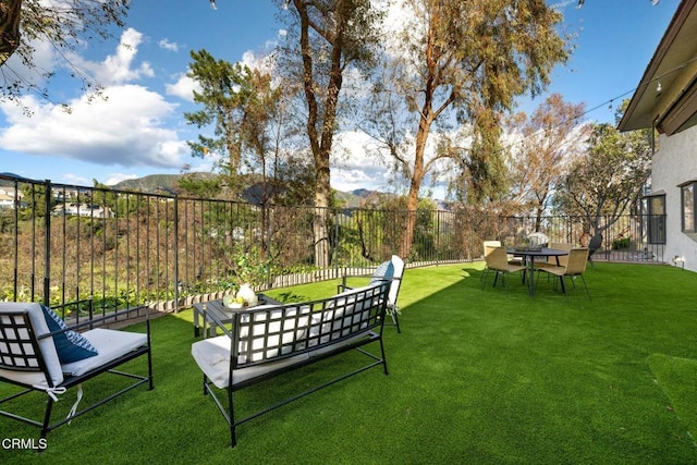view of yard featuring a mountain view and fence