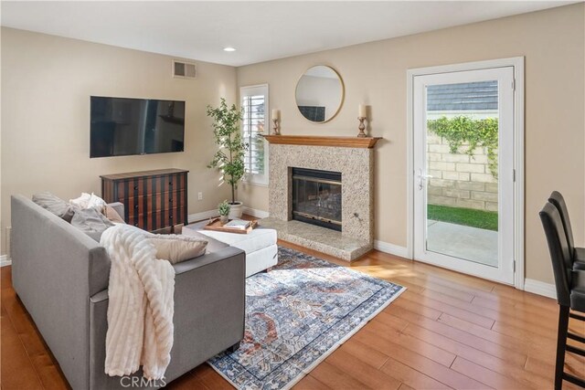 24118 Saint Moritz Dr, Valencia, CA 91355 - living area featuring wood finished floors, recessed lighting, and a high end fireplace