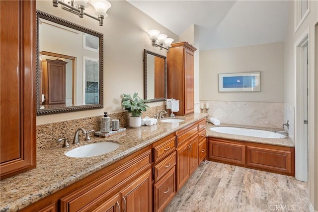 24118 Saint Moritz Dr, Valencia, CA 91355 - full bathroom with double vanity, wood finished floors, and a bath