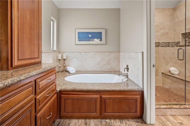 24118 Saint Moritz Dr, Valencia, CA 91355 - bathroom with a shower stall, a bath, and wood finished floors