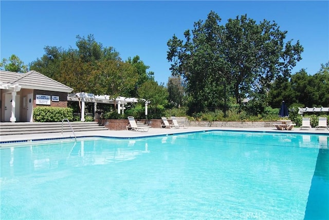24118 Saint Moritz Dr, Valencia, CA 91355 - community pool with a pergola and view of scattered trees