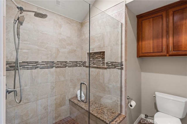 full bath featuring a shower stall and toilet