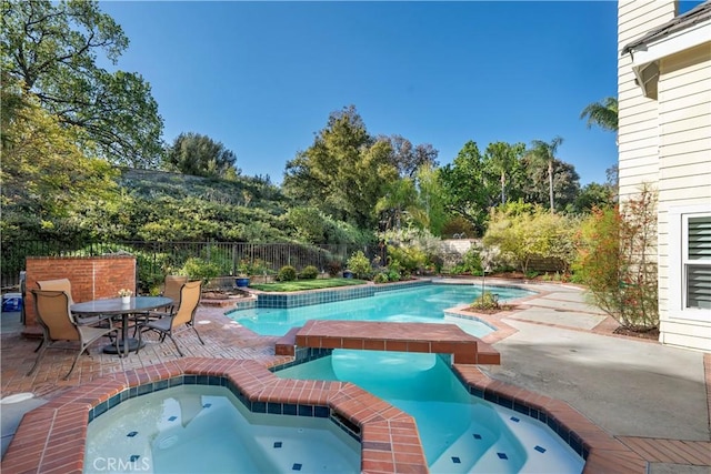 view of pool featuring a fenced in pool, a patio area, an in ground hot tub, and fence
