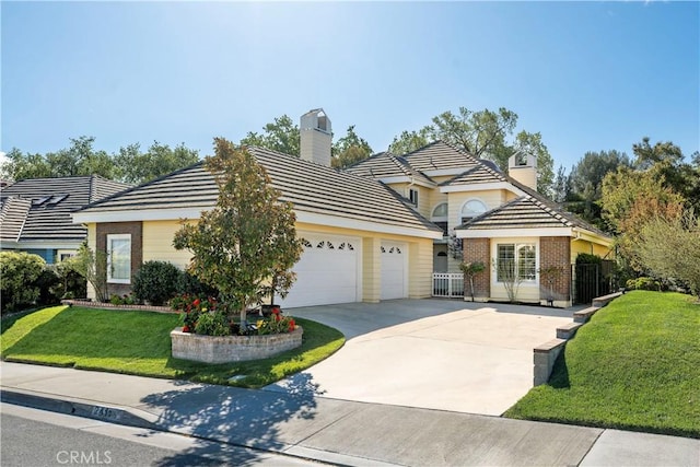 traditional-style house with a chimney, fence, a garage, driveway, and a front yard