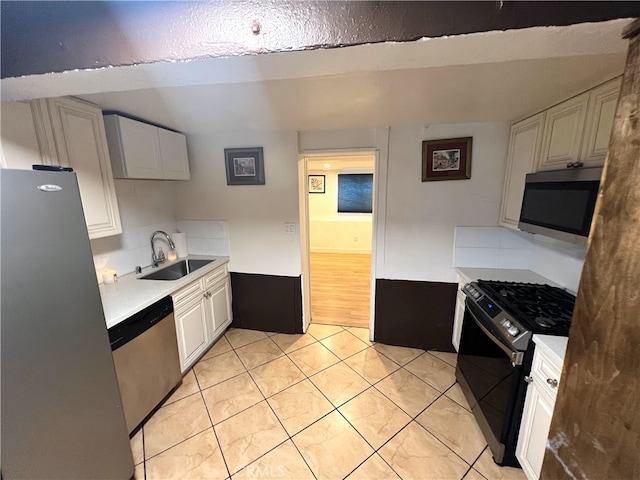 1708 E 3rd St, Los Angeles, CA 90033 - kitchen featuring light countertops, appliances with stainless steel finishes, light tile patterned floors, and a sink