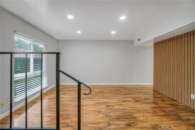 below grade area featuring baseboards, recessed lighting, and wood finished floors