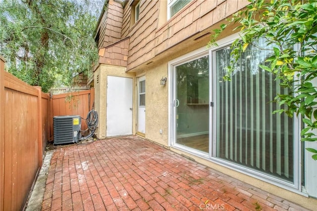 view of patio / terrace with a fenced backyard and central air condition unit