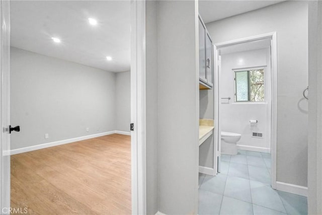 bathroom featuring toilet, baseboards, recessed lighting, and vanity