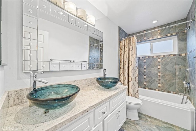 full bathroom with double vanity, shower / tub combo, toilet, and a sink