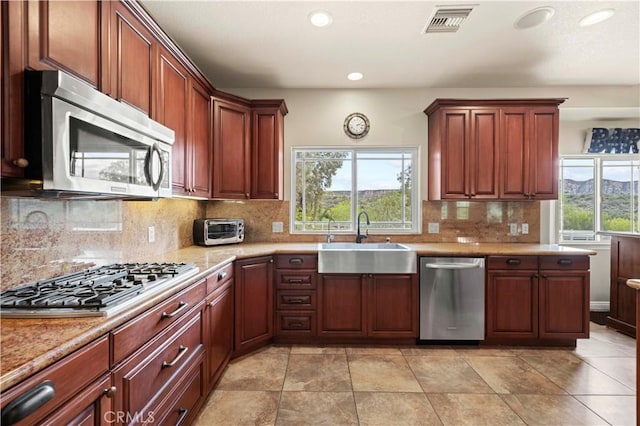 kitchen with tasteful backsplash, visible vents, a sink, recessed lighting, and stainless steel appliances