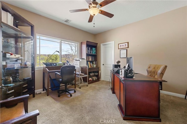 office with light carpet, visible vents, baseboards, and ceiling fan