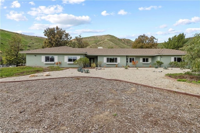 view of front of house with a mountain view and stucco siding