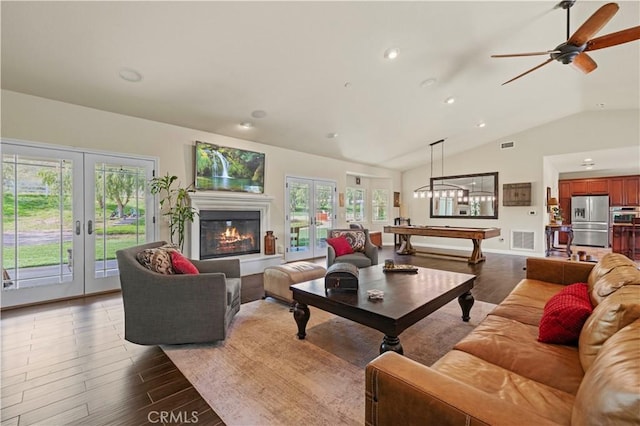 18181 Lost Creek Rd, Saugus, CA 91390 - living room featuring french doors, lofted ceiling, plenty of natural light, wood finished floors, and recessed lighting