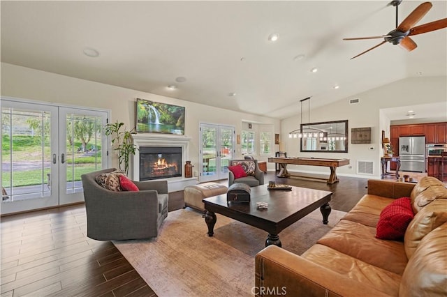 18181 Lost Creek Rd, Saugus, CA 91390 - living area featuring french doors, lofted ceiling, plenty of natural light, wood finished floors, and recessed lighting