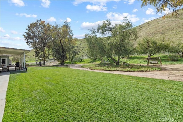 view of community featuring a patio and a yard