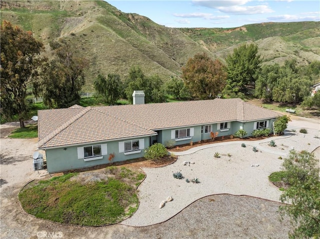 18181 Lost Creek Rd, Saugus, CA 91390 - view of front of property with stucco siding, a mountain view, a chimney, and a tiled roof