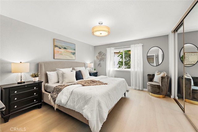 bedroom featuring a closet and light wood-style floors